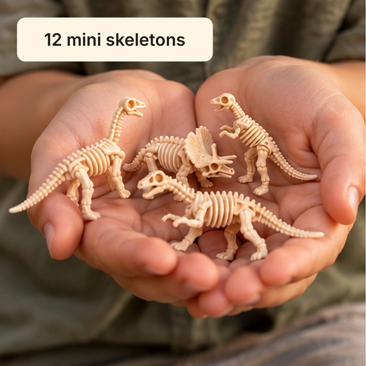 Hands holding a pile of mini dinosaur skeleton figures